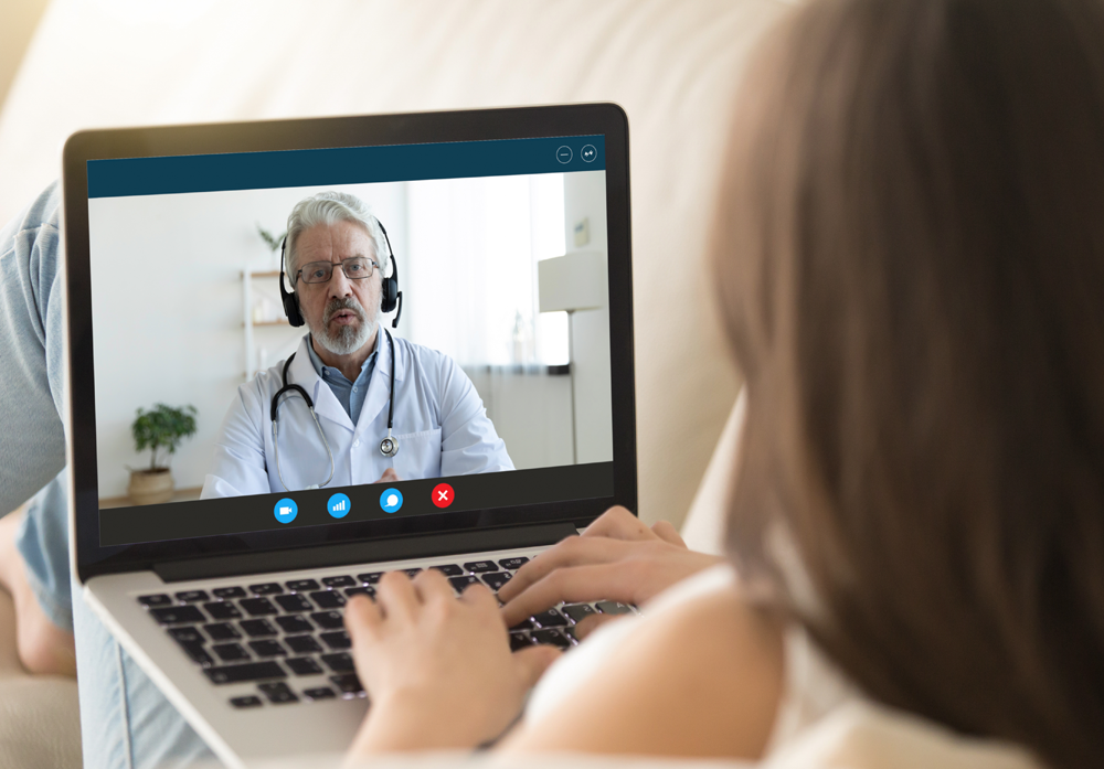 a person in a call meeting using a laptop