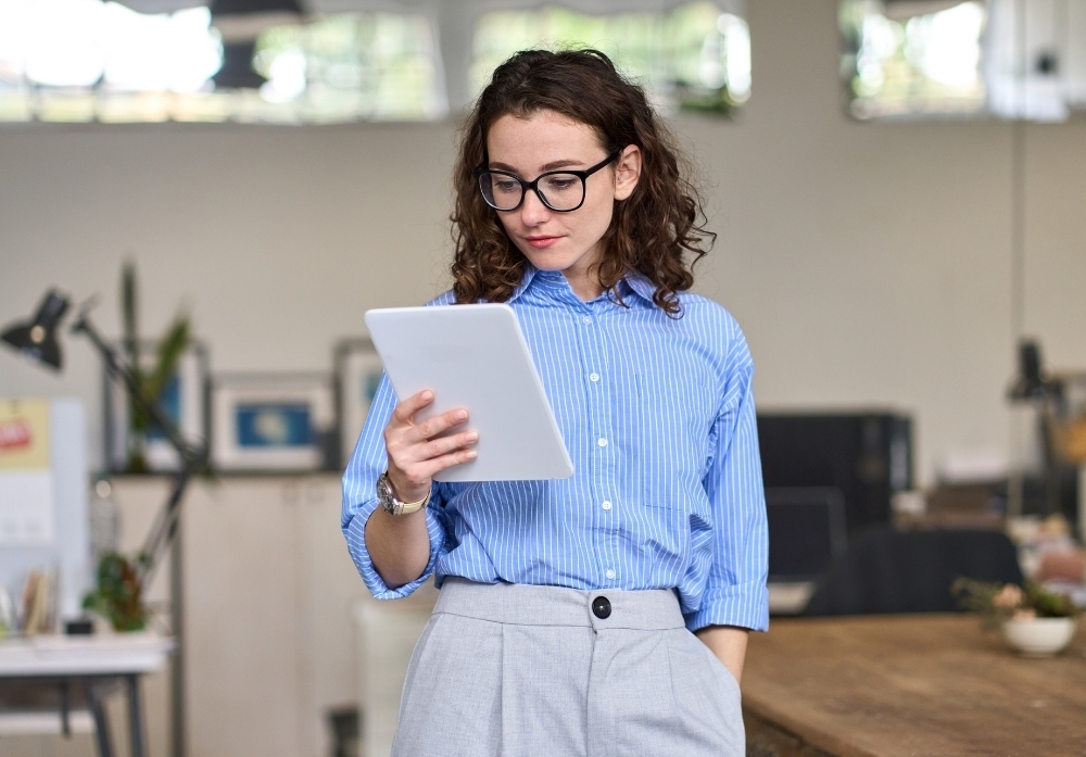 a woman reading in a tablet