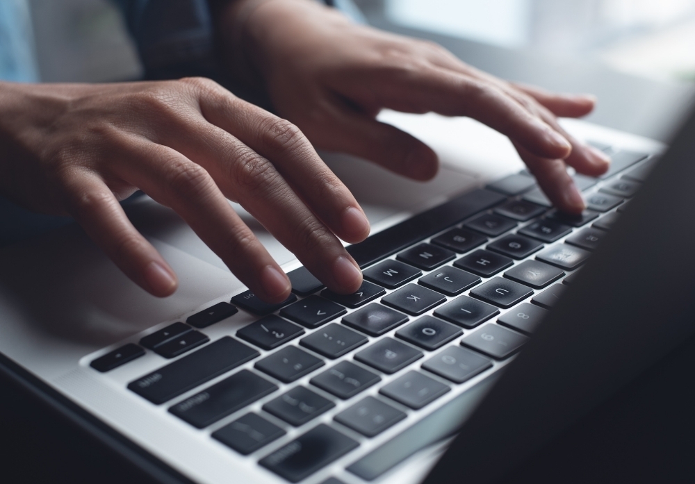 Person Typing on a Keyboard