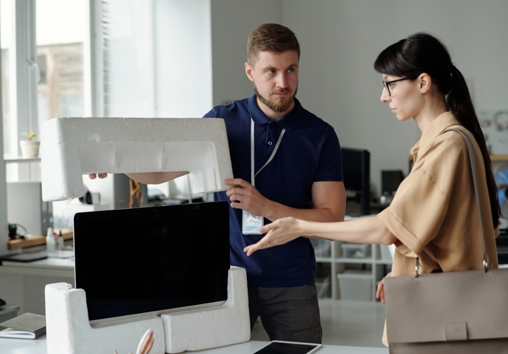 people unpacking a monitor in the office