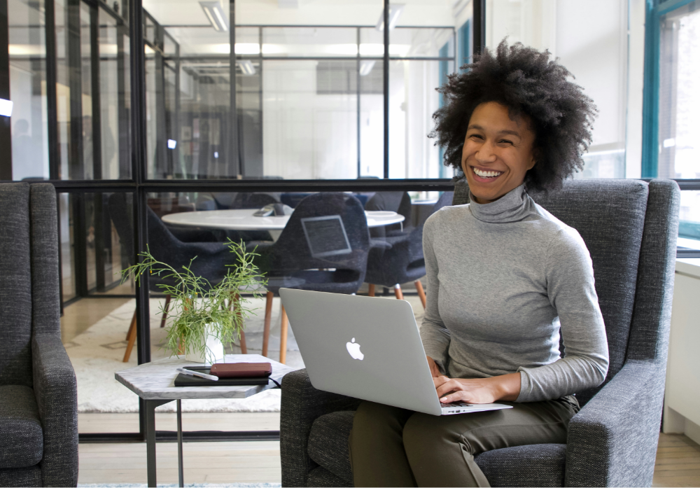 woman using a mac laptop in the office