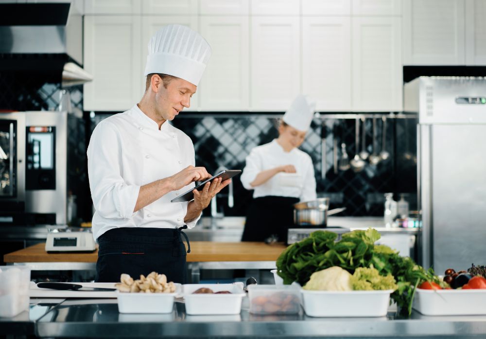 chef checks an ipad in a restaurant