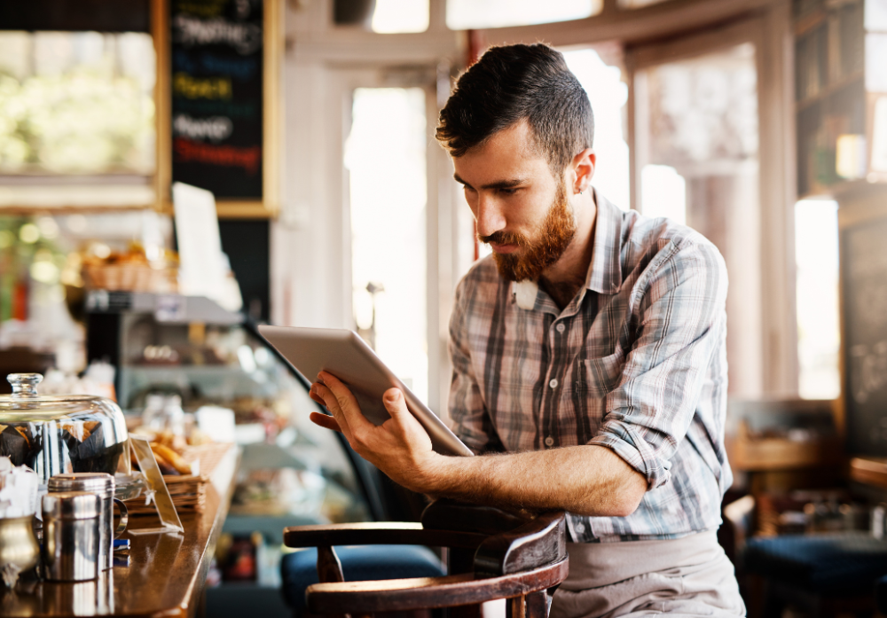 man checking a tablet in a restaurant